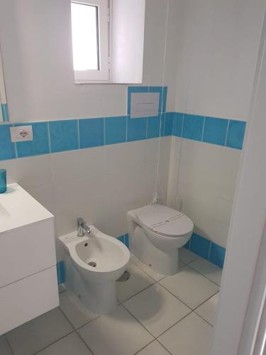 a bathroom with a toilet and a sink at Residenza d'epoca Olimpia in Santa Maria di Castellabate