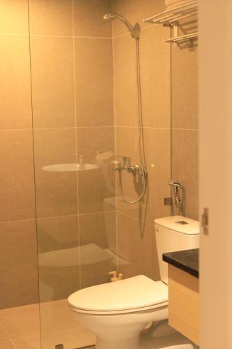 a bathroom with a toilet and a glass shower at The Charm Boutique Hotel in Hue in Cồn Giả Viên
