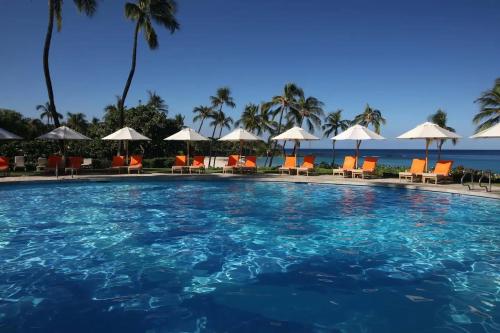 a large swimming pool with chairs and umbrellas at ❤PiH❤ Ikena Nani Ocean Coastline Views Mauna Kea Resort in Waimea