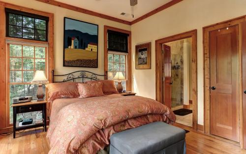 a bedroom with a bed in a room with windows at Lake Escape - Lounge with Scenic Lake Views in Dawsonville