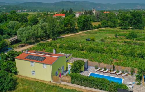 an aerial view of a house with a solar roof at Beautiful Villa Vrljika with pool in Makarska in Grubine