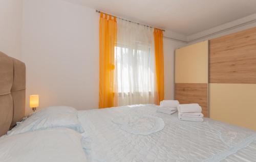 a bedroom with a large bed with towels on it at Beautiful Villa Vrljika with pool in Makarska in Grubine