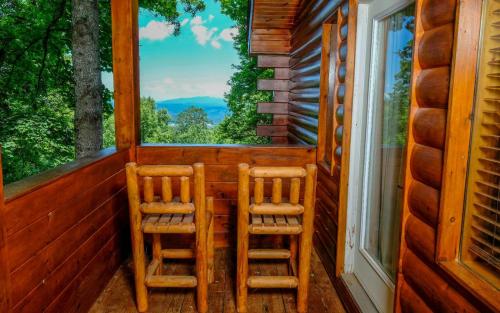 two chairs sitting on the porch of a cabin at Smoky Getaway in Gatlinburg