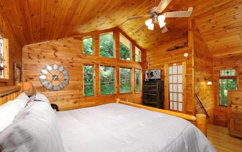 a bedroom with a large bed in a log cabin at Smoky Getaway in Gatlinburg