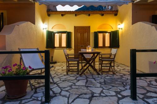 a patio with chairs and a table in a building at Renata Rooms & Studios in Barbati