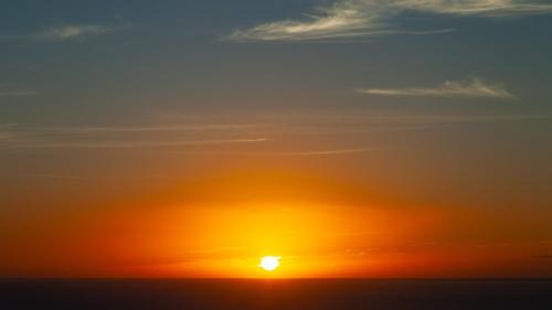 a sunset over the ocean with the sun in the sky at MAUNA KEA BEACH ESCAPE Luxurious home in private community with Heated Private Pool and Spa Detached Ohana Suite in Waimea