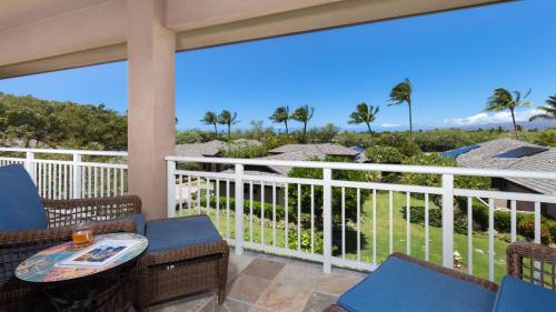 a porch with chairs and a table with a view of the ocean at SUNSET VILLA Spacious Mauna Lani 3BR Home With Private Beach Club in Waikoloa