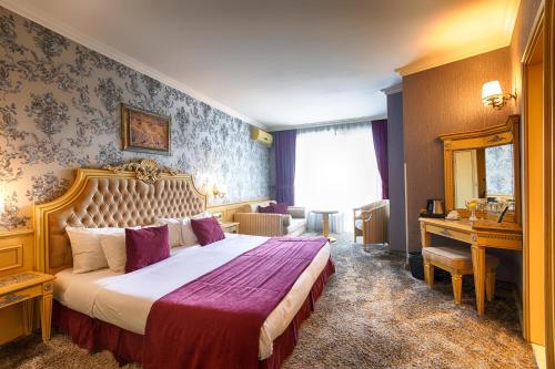 a bedroom with a large bed in a room at Spa Hotel Rich in Velingrad