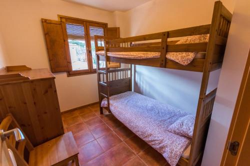 a bedroom with two bunk beds in a house at Lo Planet in Beceite