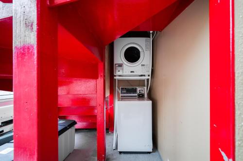 a small room with a microwave and a refrigerator at Sunshine Inn 456 - Economic APT in Tokyo Tranquil Block, with Direct Access to Ginza & Akihabara in Tokyo