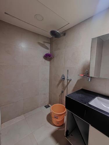 a bathroom with a sink and a shower and a toilet at Aasra in Dehu Road