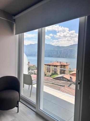 a room with a window with a view of the ocean at Hotel Diana in Malcesine
