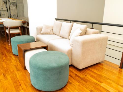 a living room with a couch and two ottools at Seraphic Hills in Haputale