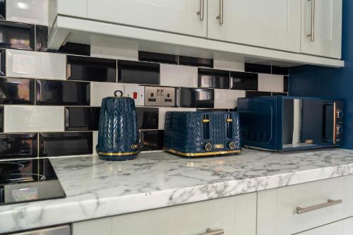 a kitchen counter with three microwaves on it at Games Room free Parking House in Bristol