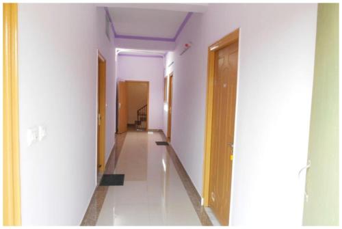 a hallway with white walls and a purple ceiling at HOTEL DS STAY VARANASI ! - Near Kasi Vishwanath Temple And Ganga Ghat #Fully Air Conditioning #Free Wi-Fi #Parking #Room Service #Prime Location - Best Selling Premium Hotel in Varanasi in Varanasi