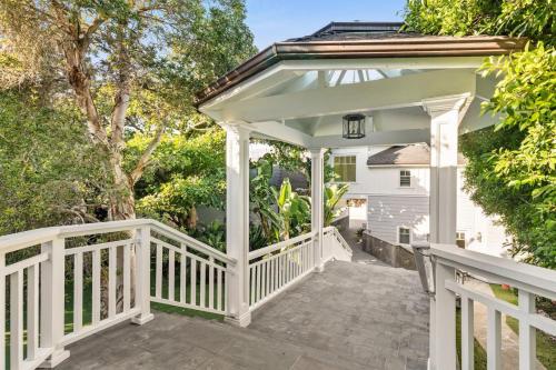 a white gazebo on a porch with trees at Malibu Dunes by Fieldtrip Expansive Hamptons-Style Estate w Private Beach Backyard in Malibu