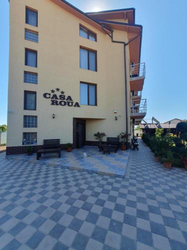 a building with benches and a sign on it at Casa Roua in Venus