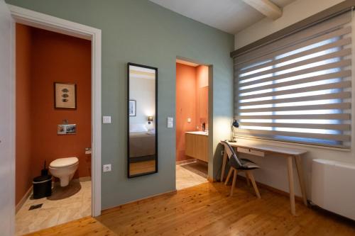 a bathroom with a sink and a toilet and a mirror at Tinas Home - Kalamata Mediterranean Villas in Kalamata