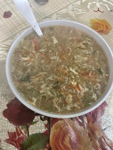 a bowl of soup sitting on top of a table at Mountain Dale Guest House in Gilgit