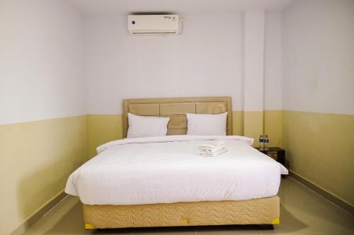 Ένα ή περισσότερα κρεβάτια σε δωμάτιο στο SANS Stay Manlie Hotel & Residence
