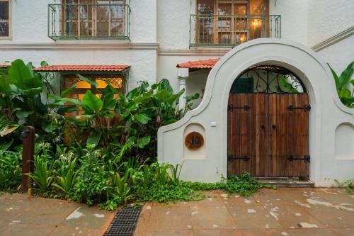 a wooden door in front of a building at Luxury Villa With Private Pool, 4-BHK, Assagao in Assagao