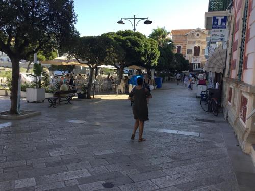 a woman walking down a street in a city at Palazzo Caputo in Nardò
