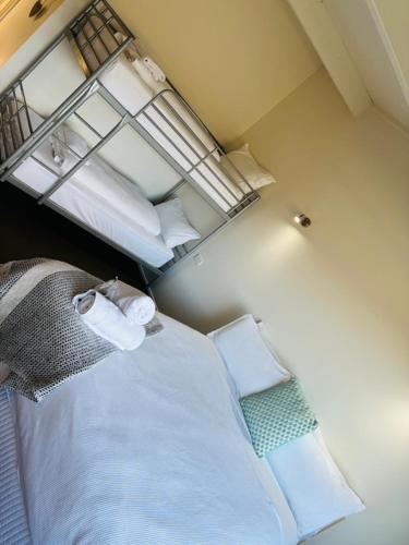 a small room with a bed and a window at Cedar Apartments - Merrijig in Merrijig