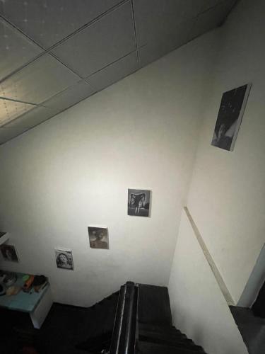 a white wall with pictures on it at Rani Homestay & Restaurant in Gampola