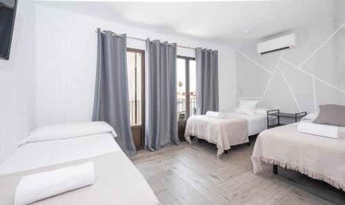 Postel nebo postele na pokoji v ubytování Hostal Costa