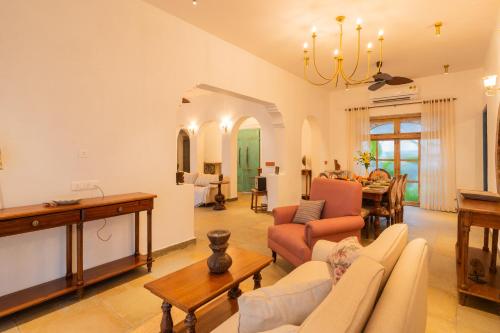 a living room with a couch and a table at Luxury Villa With Private Pool, 4-BHK, Assagao in Assagao