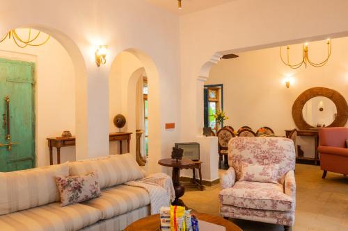 a living room with a couch and a chair at Luxury Villa With Private Pool, 4-BHK, Assagao in Assagao