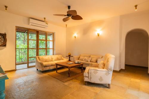 a living room with two couches and a ceiling fan at Luxury Villa With Private Pool, 4-BHK, Assagao in Assagao
