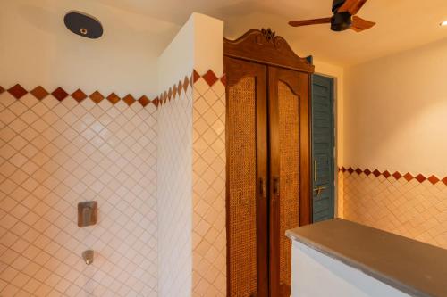 a bathroom with a shower and a ceiling fan at Luxury Villa With Private Pool, 4-BHK, Assagao in Assagao