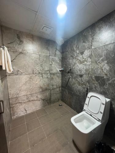 a bathroom with a toilet and a shower at Hotel Classic Plaza, Simara in Simra