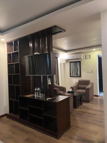 a living room with a couch and a table with a lamp at Hotel Classic Plaza, Simara in Simra