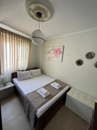 a small bedroom with a bed and a lamp at Nikos Apartament in Prinos