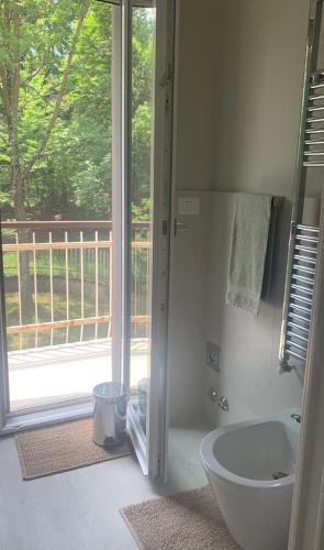 a bathroom with a tub and a shower with a window at Nature - Joy in Val Della Torre
