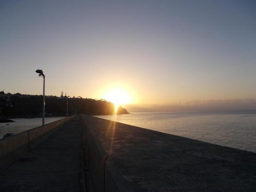 a sunset over the ocean with the sun setting at Apartamentos La Banda in Playa de Santiago