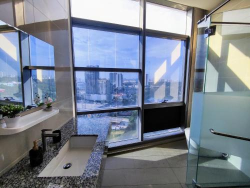 a bathroom with a sink and a large window at 4 Rooms 7 Beds 4 Baths at KLSunwayPJ in Petaling Jaya