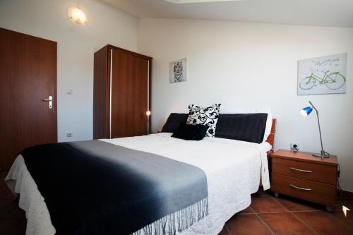 a bedroom with a large bed and a wooden cabinet at Apartment Paulina in Trogir
