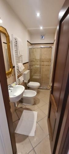 a bathroom with a toilet and a sink and a shower at B&B Montisclari in Monchiero