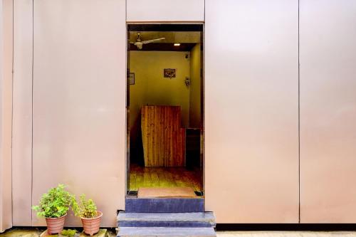 a hallway with potted plants in a building at FabExpress Sumit Palace in Mumbai