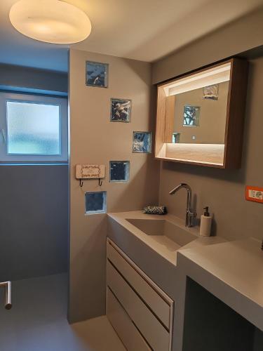 a bathroom with a sink and a mirror at Apartments Mirta in Rovinj