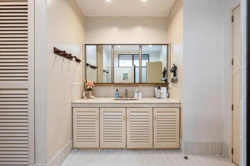 a bathroom with a sink and a mirror at Private Beach Villa in Anza Mactan with Ocean View in Punta Engaño