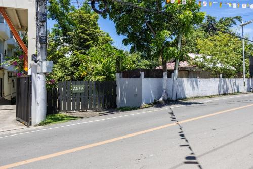 an empty street with a fence on the side of the road at Private Beach Villa in Anza Mactan with Ocean View in Punta Engaño