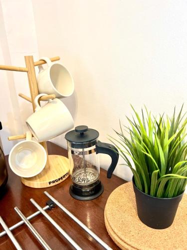 a kitchen counter with a coffee maker and a plant at Angel's Place Torre De Manila, Cozy 1BR Condo, Sunset View Near all Attractions in Manila