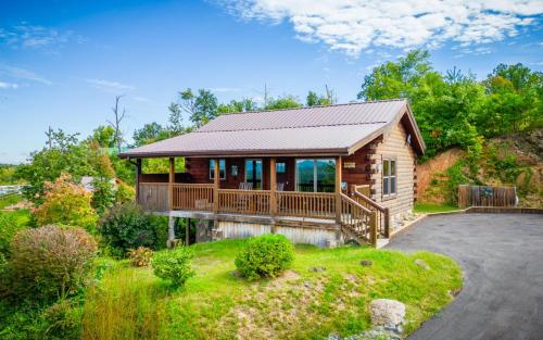 a log home with a deck and a porch at Journey's End in Gatlinburg