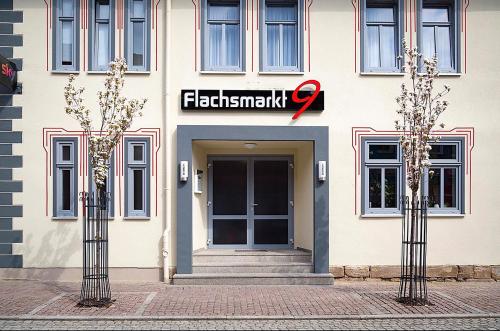 a building with a sign on the front of it at Pension im Fleischinstitut in Nottertal-Heilinger Höhen
