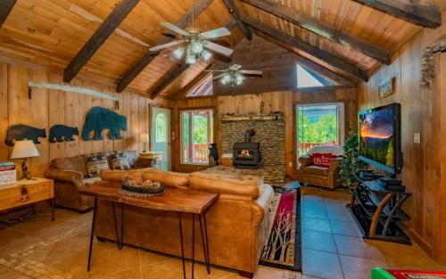 a living room with a couch and a fireplace at Treetop Retreat in Gatlinburg