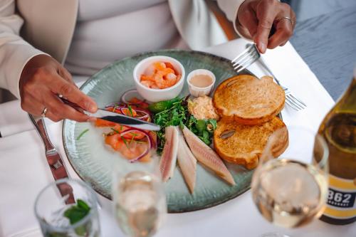 a plate of food on a table with a plate of food at Van der Valk Hotel Den Haag in Nootdorp